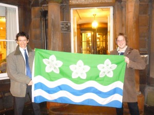 Photograph of Rory Stewart MP and Philip Tibbetts with the Cumberland Flag - Credit: Gethin Jenkins (Office of Rory Stewart MP)